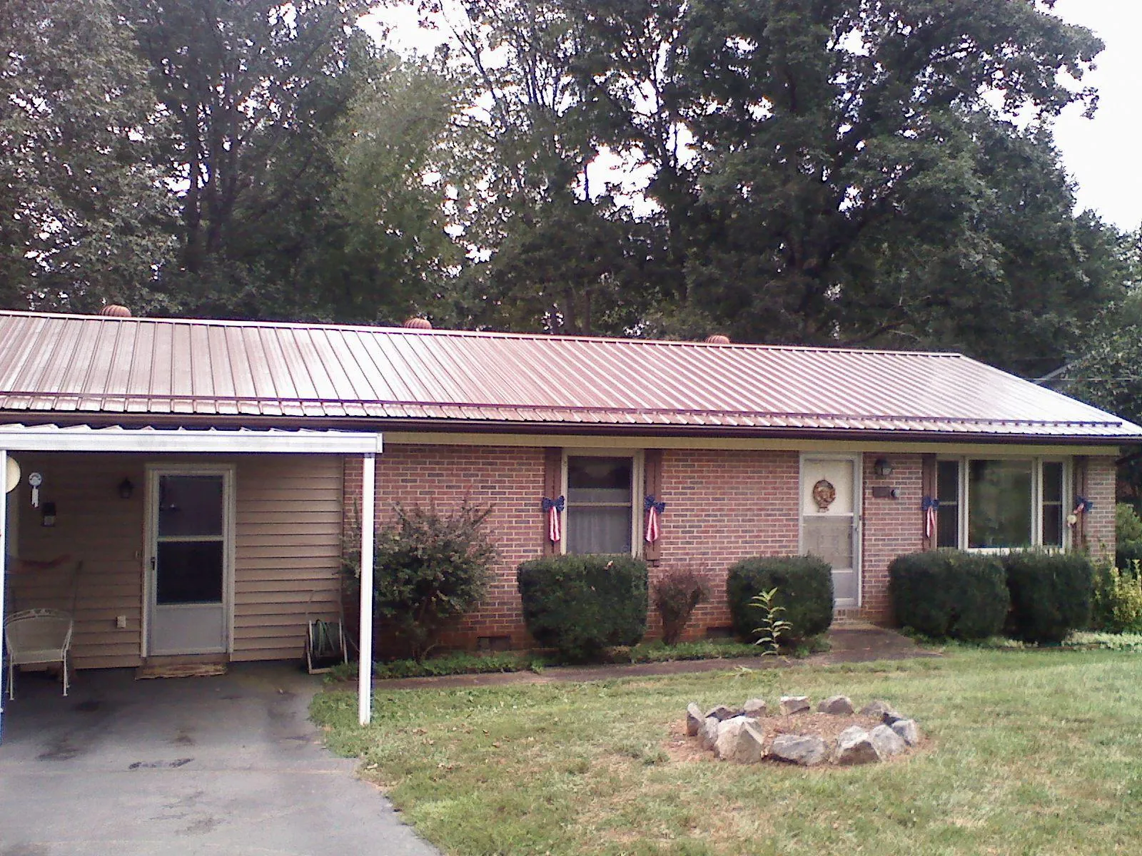 Bronze metal roof and carport on a brick ranch home — Roof Repair work by our crew in Rancho Santa Margarita